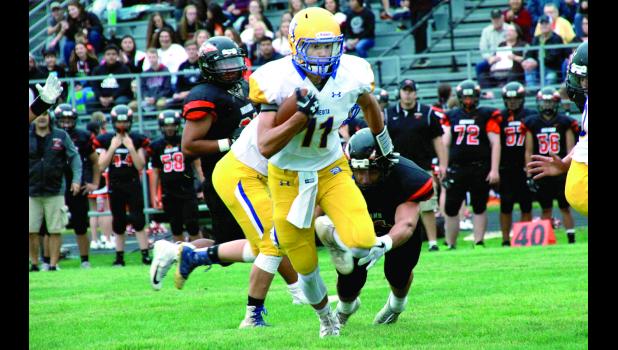 Staff Photo by Byron Higgin Thomas Hennen ran the ball against Sleepy Eye.