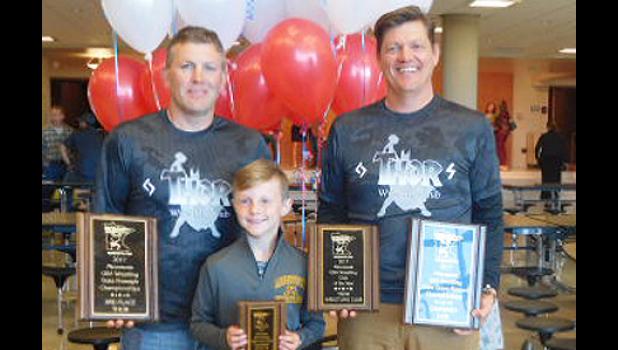 Special photo. Coach Travis Christenson, Lincoln Christenson and Coach J.D. Pesch posed with their awards for the THOR Wrestling Club.