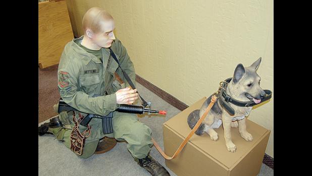 Staff photo by Scott Thoma. Currently, the dog and handler display in the downtown museum features a mannequin soldier in combat gear kneeling beside a small dog.