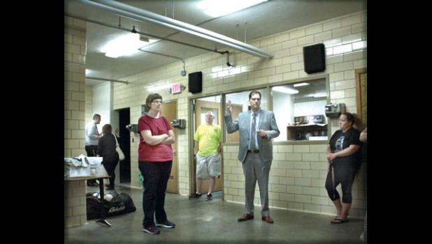 Staff Photo by Byron Higgin. During the first tour of the Minneota School last week, Supt. Dan Deitte (center) brought the visitors to the locker rooms in the basement of the school. One thing noted was the poor lighting. “The hallways were even more dingy and in need of new lighting,” said Supt. Deitte.