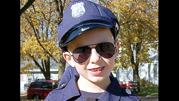 Staff Photo by Scott Thoma. Lee Bottelberghe, 6, was policing the parking lot at St. Edward's School in search of some candy.