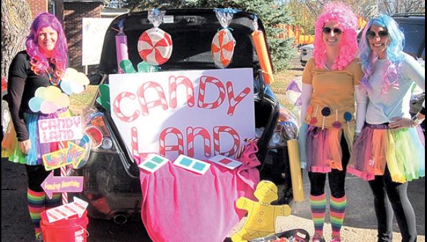Staff Photo by Scott Thoma. One of the 13 decorated trunks was this Candy Land theme. From left to right, above: Emily Hennen, Nikki Traen, and Sara Gorecki.