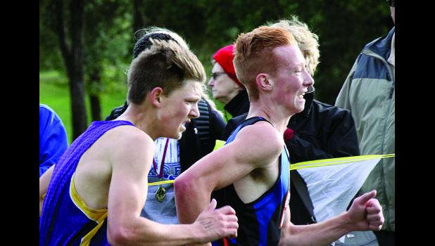 Staff Photo by Byron Higgin Jalyn Ufkin of Canby-Minneota just got past Bryce Nelson of Montevideo at the finish line to place 13th in the meet at Granite Falls on Thursday.