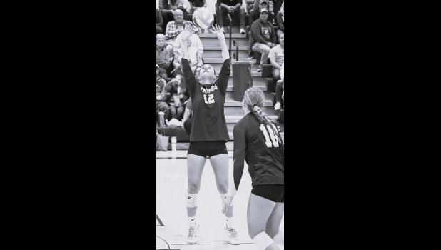 Mascot photo by Reba Lipinski Minneota senior Faith Myhre sets the ball for a teammate last Tuesday against Ortonville.