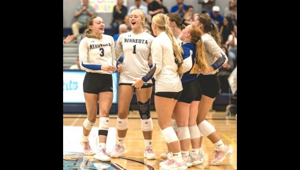 Minneota players celebrate after winning a set against Russell-Tyler-Ruthton last Thursday night in Tyler. 