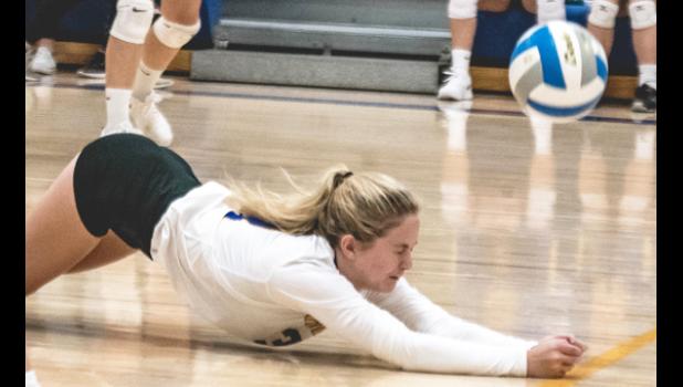 Photo for the Mascot by Brian Jeremiason. Ellie Pesch dives to dig up a Canby attack last Friday against Canby.