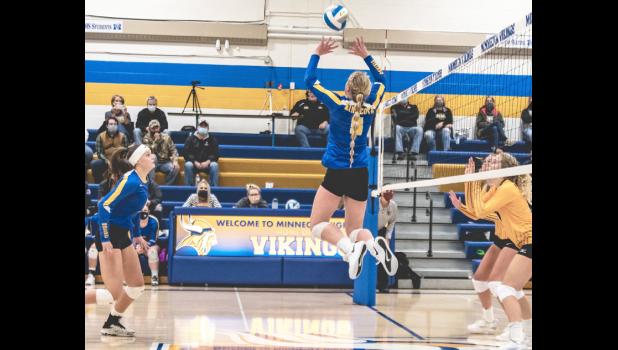 Mascot photo by Brian Jeremiason Minneota's Abby Frie, left, and McKenna Yost go up for a block against Dawson-Boyd on Thursday night.