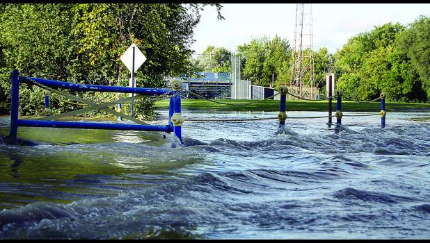 Staff Photo by Byron Higgin The Yellow Medicine River went over its banks at the K. P. Kompelien Park area again Thursday.