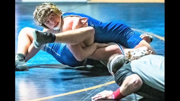 Mascot photo by Brian Jeremiason Minneota 160-pounder Alex DePestel looks over at the clock to check how much time is remaining before pinning his Adrian Area opponent with nine seconds left in the first period on Thursday in Minneota.