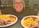City Hall Bar & Grill waitress Julie Pohlen shows the brisket platters customers were served for the Scotty Biggs BBQ Night on Saturday. 