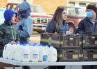  Josiah Sternke, Naomi Sternke and Joe Tillemans help pass out food and milk. 
