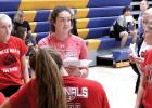 Taya (Kockelman) Lindahl (upper, left), talked things over with her players at the Minneota scrimmage. 