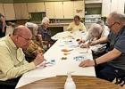 Clockwise from lower left: Steve Anderson, Victoria White, Jeanette DeCock, Cathy Halverson, Rita LaVoy, Bernice Bossuyt, Tony Fier. Barb Okrina, the monthly Arts & Crafts coordinator is in the background with a heating tool used to dry the paint between colors. 