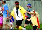 Dakota Matherly with Colton David DeRoode in the Fun Run. Kyle Thooft is behind them.