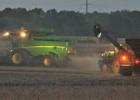 Farmers, such as these harvesting beans northeast of Minneota, often harvest well into the night. 