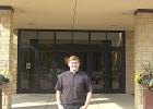 Father Joshua Bot stands in front of St. Mary’s Catholic Church in Willmar, where he was installed four months ago. 
