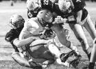 Wyatt Moore, lower left, of Minneota brings down a YME ball carrier while getting help from Sawyer Bradley (22) and Sam Myhre (7).