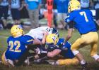 Anthony Rybinski (22) and Jonah Gruenes (center) being down RTR's Cody Wichmann after a short gain as Tucker Thooft (7) looks on. 