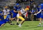 Minneota's AJ Josephson breaks out of the grasp of MACCRAY's Dreyer Homan (22) and scampers 61 yards for a score in the second quarter. 