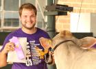 Grady Moorse proudly displays his champion ribbon at the 4-H dairy show during the Yellow Medicine County Fair. 