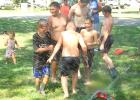 With temperature in the uppers 80s, the Porter Fire Department placed a sprinkler in the park, which many kids and some adults used to cool off during Harvest Festival on Saturday. 