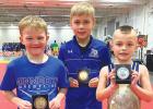 The Minneota K-6 wrestlers who placed individually at the NWYA State Tournament, left to right: Bryson Javers, seventh place at 50 pounds; Derek Fier, eighth place at 64 pounds; and Jacob Myrvik, second place at 45 pounds.