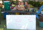 Jamie Lanners, right, posed with her daughters Ariana, 6, left, and Ella, 8, and son, Ian, 8 months last Tuesday in Minneota as the girls sold lemonade and flowers to raise money for their father, Galen, who is battling cancer.