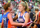 Lizzy Gillingham (right) was all smiles as she welcomed RyAnn Hansen with a hug after the 4x400-meter relay team placed second and earned a trip to the state.
