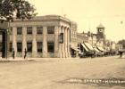 In this photo taken in the 1920s, the photographer is looking east at the intersection of Main and Jefferson Streets. Note the bank clock, which is still visible today. Also note the horse fountain in the middle of the street, which has long since been removed.