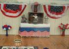 Several windows along the Jefferson Street business district feature displays for Memorial Day, including this one at Minneota Public Library. The Senior Center and the Mascot also have red, white and blue displays to honor veterans. 