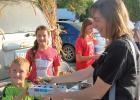 Harry Swedzinski smiles as he sells eggs to Melissa Friedrichs during the weekly Farmers Market in Minneota. 