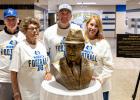 Gerhard and Nancy Meidt’s children posed with the bronze bust of their father on Friday. Left to right: Greg Meidt, Karen Meidt, Chris Meidt and Melody (Meidt) Leidall.