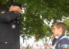  1st Sgt. David “Dude” Myhre, the guest speaker at the Minneota Memorial Day program, and William Desmedt, a member of the Minneota Cub Scouts, salute one another at Veterans Park. 