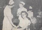 Mrs. Joe Moorse checks the pulse of Mrs. Virgil Ufkin, while Mrs. Harold Kile checks Mrs. Ufkin's temperature during a Red Cross Blood Drive in Minneota on Aug. 1, 1950 at the public school. The nurse in the background is Mrs. Jack Finnegan, who is checking Mrs. Orval Spanton. The were 155 pints of blood donated during this drive.