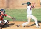Mudhens catcher Austin DeVlaeminck hits a sacrifice fly to center field in the third inning against Dawson on Saturday in Madison. The Dawson catcher is Braden Thompson. 