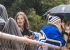 Minneota Homecoming Queen Molly Krog got a bit wet as others used umbrellas during the Minneota win over MACCRAY, 36-8.