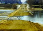 The water covers the fields and flowed over the road.