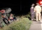 The tractor was tipped on its side in the ditch.