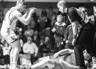 Cael Fier, left, of Minneota points to teammates after pinning Canby's Jordan DePestel in their heavyweight match last Thursday. 