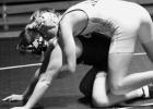 Sam Myhre of Minneota works on turning Easton Jaenisch in a dual against Quad County last Thusday in Clara City.